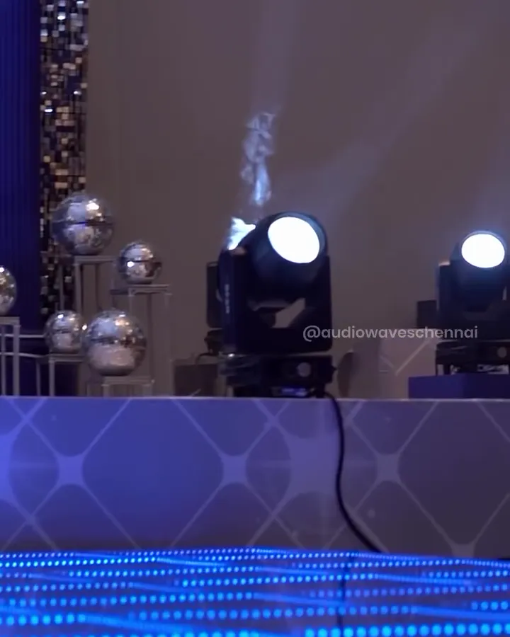 Moving-head lights beside the stage over the 3D dance floor